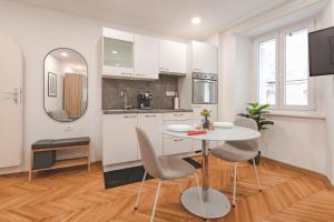 a kitchen and dining room with a table and chairs at Studio apartment in the heart of magic Piran in Piran