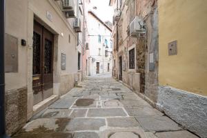 an alley in an old town with a stone walkway at Studio apartment in the heart of magic Piran in Piran