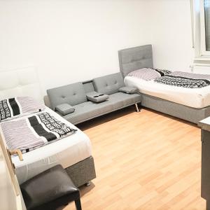 een woonkamer met 2 bedden en een bank bij FMI9Accomation Raunheim in Raunheim