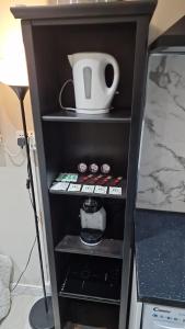 a black shelf with a tea pot on top of it at Oleon Apartments - Colchester in Colchester