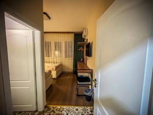 a room with a bedroom with a bed and a door at Calla Bella Rooms & Snack Bar in Skopje