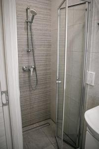 a shower with a glass door in a bathroom at Birzebbuga -Two Bed Penthouse in Birżebbuġa
