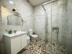 a bathroom with a shower and a sink and a toilet at Calla Bella Rooms & Snack Bar in Skopje