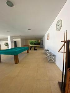 a room with a ping pong table and a clock at Apartment with Breathtaking view in Praia da Areia Branca