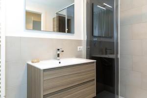 a bathroom with a sink and a mirror at Wave Island! Luxury resort a Jesolo - Piscina e Park free! in Lido di Jesolo +32 photos