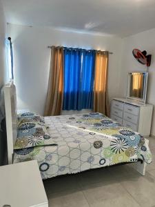 a bedroom with a bed and a dresser and a window at Yobcar66 in San Fernando de Monte Cristi