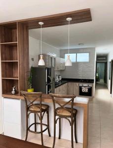 a kitchen with two chairs and a table in a kitchen at Apartamentos la flora in Cali