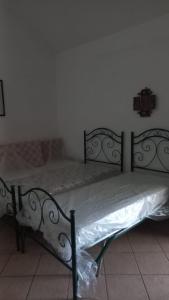 a bed in a room with a white bedvisor at Trullo Oasi di Pace in Ceglie Messapica