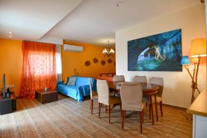 a living room with a dining table and a bedroom at Villa Filoxenia all seasons, near airport, sea, Athens in Aghia Marina