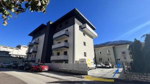 a building with cars parked in a parking lot at Bolghera House in Trento +29 photos