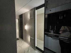 a kitchen with stainless steel cabinets and a stove at Apartament Miami in Ełk