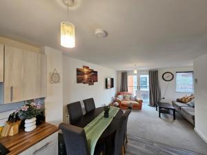 a kitchen and living room with a table and chairs at Modern 3 Bedroom Town House in Ipswich in Ipswich