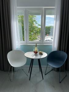 a table and two chairs in front of a window at A-more accommodation in Split