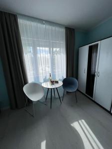 a room with a table and two chairs and a window at A-more accommodation in Split