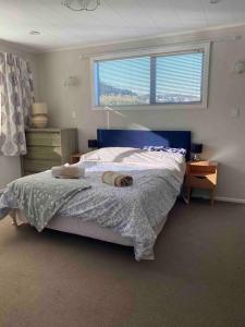 a bedroom with a bed and a window in it at 3 bed apartment with stunning harbour views in Lower Hutt