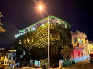 a building with ivy on the side of it at night at Hotel Bella in Selçuk