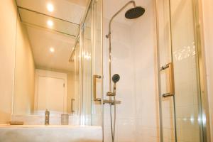 a shower with a glass door next to a sink at FLH Victory Village Apartamento Quinta do Lago in Almancil