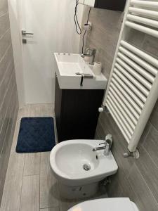a bathroom with a white toilet and a sink at Casa Vacanze Chiara in Trieste