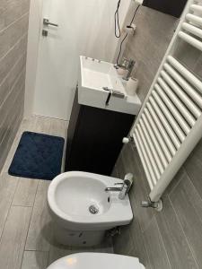 a bathroom with a white toilet and a sink at Casa Vacanze Chiara in Trieste