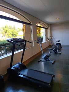 a gym with three exercise bikes and a window at Flat encantador localizado no melhor de Serra Negra - SP in Serra Negra