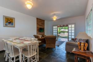 a dining room with a table and a couch at Positano Ilhabela Lodges in Ilhabela