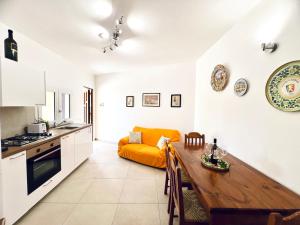 a kitchen with a table and a couch in a room at L'Angolo del Saraceno in Carini
