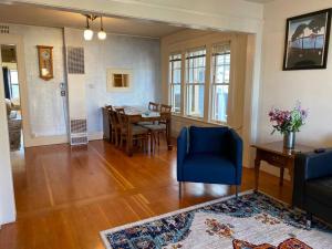 a living room with a table and a blue chair at Historic Downtown Flat, #3 in Astoria, Oregon