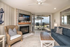 a living room with a couch and a fireplace at D-31 Beachfront Bliss in Oceanside