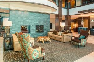 a lobby with couches and chairs and a fireplace at Sheraton Mesa Hotel at Wrigleyville West in Mesa