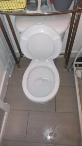 a white toilet in a bathroom with the seat up at Auberge PVT Hostel in Montreal +62 photos