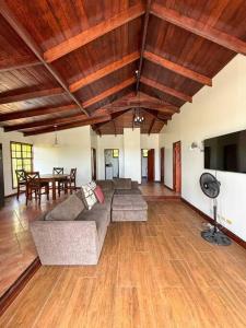 a living room with a couch and a table at Come Enjoy Lakeside Bungalow in Gros Islet