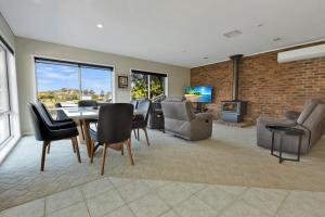 a living room with a table and chairs and a fireplace at Clipper Cove in Paynesville