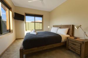 a bedroom with a bed and a window at Clipper Cove in Paynesville