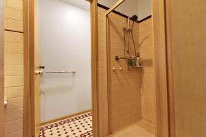 a bathroom with a shower with a glass door at Clipper Cove in Paynesville +13 photos