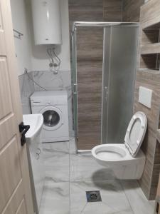 a small bathroom with a toilet and a shower at BellaVita goldap in Prokuplje