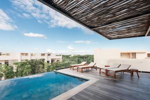 a pool on the roof of a building at Xambé in Tulum