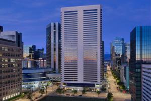 a tall white building in the middle of a city at The Ritz-Carlton, Denver in Denver