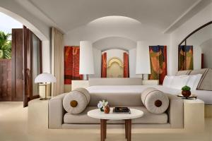 a bedroom with a large white bed and a table at Phulay Bay, A Ritz-Carlton Reserve in Tab Kaek Beach