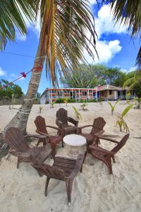 a table and chairs on the sand on the beach at Casa Rural El Paraíso de Saona in Mano Juan