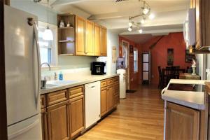 a kitchen with wooden cabinets and a white refrigerator at Riverfront Property in NRG National Park near Sandstone Falls- Wi-Fi, Pet-Friendly in Hinton