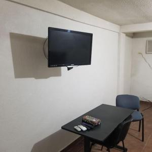 Una televisión o centro de entretenimiento en Suite con 2 recamaras,2mini splits, Parking Wifi 100 mb, cocina