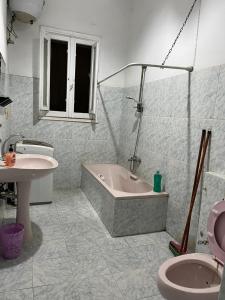 a bathroom with a tub and a sink and a toilet at Beautiful apartment in the heart of cairo in Cairo