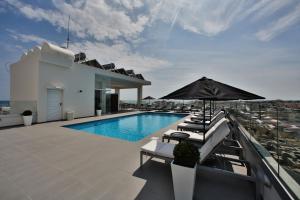 a swimming pool on the roof of a building at The Josephine Boutique Hotel in Larnaka