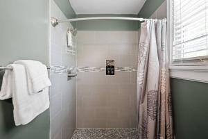 a bathroom with a shower with a shower curtain at Private House + Yard Central Location to all RVA in Richmond