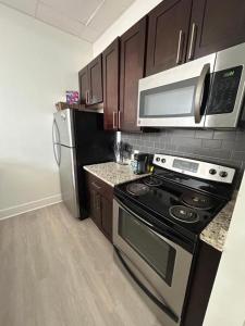 a kitchen with a stove and a microwave at White Baltimore Condo in Baltimore