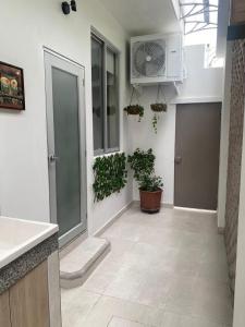 una cocina con un pasillo con plantas y un ventilador en Minisuite entrada lateral, seguridad y privacidad en Samborondón