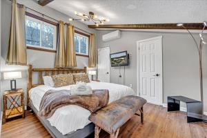 a bedroom with a large bed with a wooden headboard at 180 SKI CAMELBACK-SKI-ON -SKI OFF,SNOW TUBING,Paintball in Tannersville