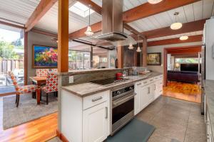 a kitchen with white cabinets and a stove top oven at Zen Meets Art Art Meets Luxury in Palo Alto