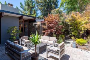 a patio with white furniture and trees at Zen Meets Art Art Meets Luxury in Palo Alto