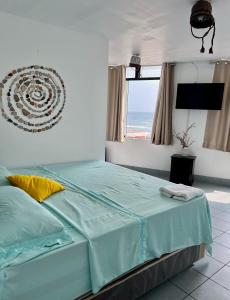 a bedroom with a bed with a view of the ocean at Bravo Surf Camp in Punta Hermosa